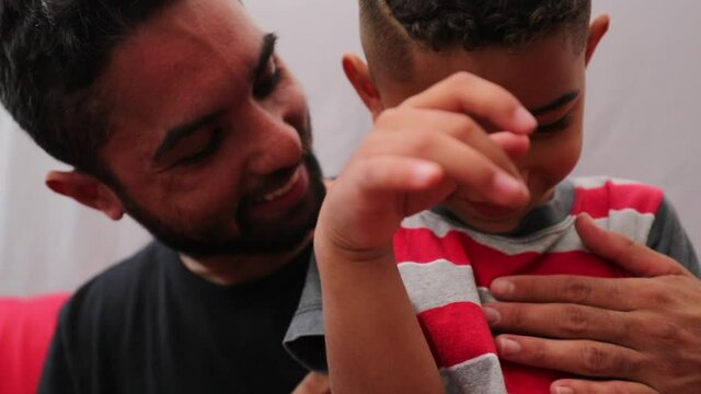 Father tickling little boy son