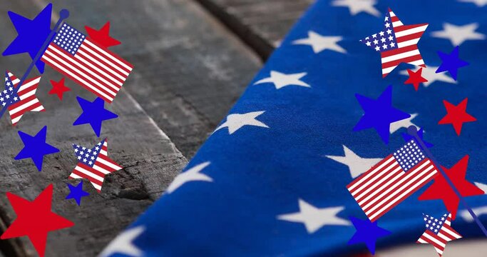 Animation of stars and stripes over american flag lying on wooden table