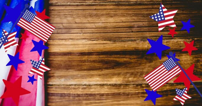 Animation of stars and stripes over american flag on wooden table