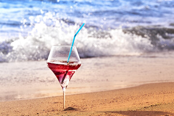 Wine glass with a cocktail by the sea.
