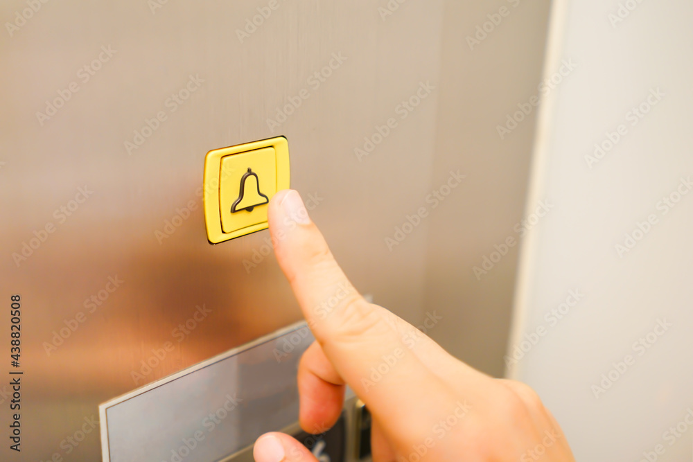 Wall mural alarm button with business man hand trying to press in the elevator, safety first and security backg