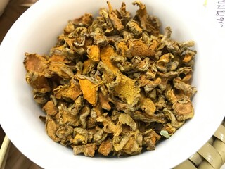 dried turmeric in white cup