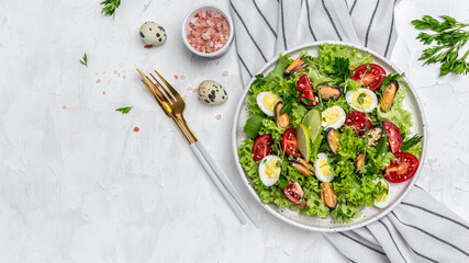 Fresh salad with mussels, quail, egg, conjugate, lime, spinach, lettuce, cherry tomatoes and microgreen. Dietary salad. Food recipe background. Close up
