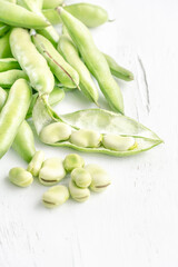 closeup fresh broad beans on a wooden table