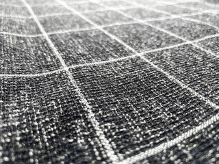 Close-up Grey checkered pattern woven cotton fabric texture background. Selective focus.