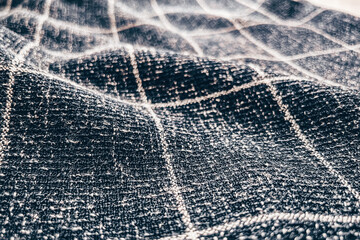 Close-up Grey checkered pattern cotton fabric texture background. Selective focus.