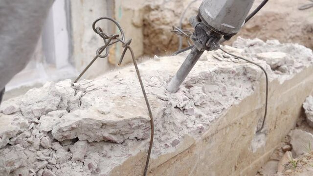 Punching solid concrete with a special jackhammer close-up, in slow motion