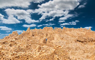 Man dressed in sky blue in the ruins of the anc&iacute;ent city of Ouadane