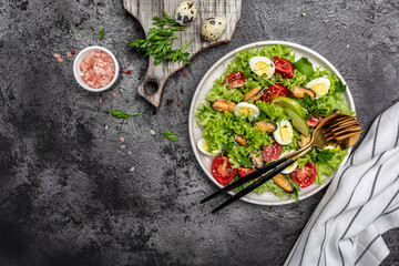 Healthy salad with mussels, quail, egg, conjugate, lime, spinach, lettuce, cherry tomatoes and microgreen. Keto lunch diet