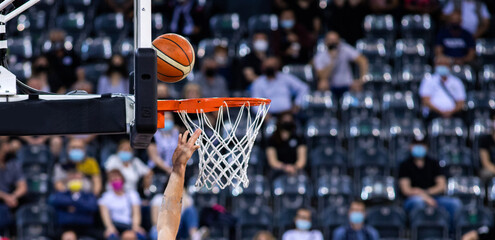 basketball going through the hoop at a sports arena