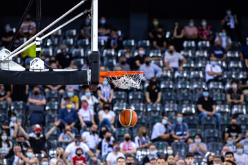 basketball going through the hoop at a sports arena