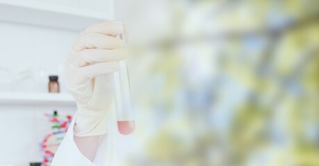 Obraz premium Composition of scientist holding test tube in laboratory with copy space