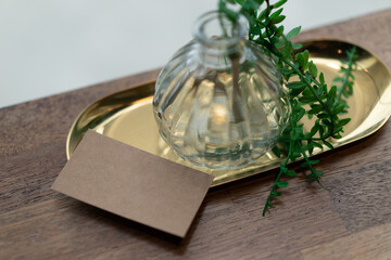 There are business cards and a vase on the table.