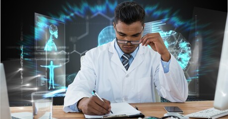 Composition of male doctor over screen with human body and medical data processing