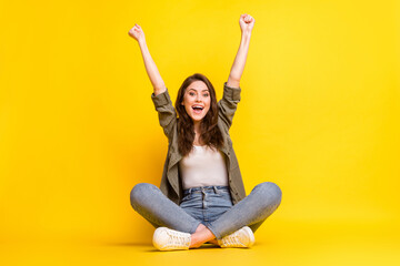 Portrait of attractive cheerful girl having fun good mood rejoicing isolated over bright yellow color background