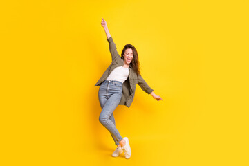 Full body photo of positive pretty girl open mouth smile partying free time isolated on yellow...