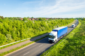 uk motorway road traffic over new build town development in england