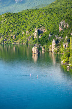 Beautiful view of lake Ohrid in North Macedonia near Trpejca in summer with paddle boarding