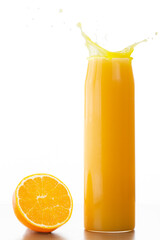 Orange juice splash in container and a half orange on its side in a studio shot