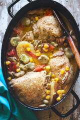 Summer chicken one pot with vegetables: potatoes, tomatoes, corn, broad beans 