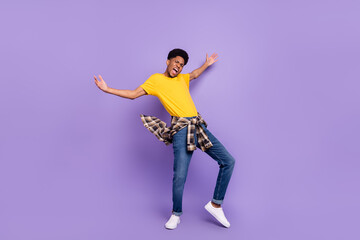 Fototapeta na wymiar Full length body size view of attractive cheerful crazy guy dancing having fun good mood rest isolated over violet purple color background