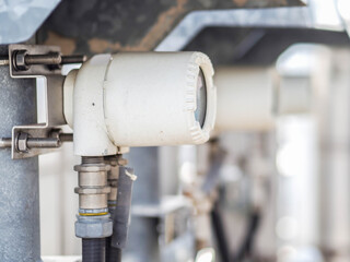 Temperature sensor for measuring instrument close up in industry zone at power plant.