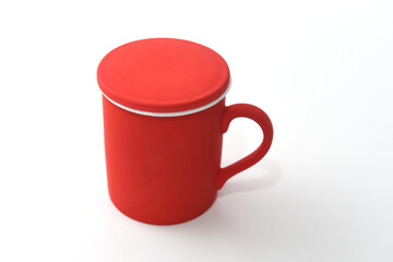 beautiful ceramic teapot mug in red color on white background