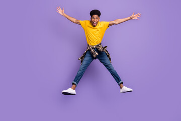 Full length body size view of attractive cheerful cool crazy guy jumping having fun isolated over violet purple color background