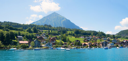 view from lake Thunersee to Faulensee tourist resort and Niesen mountain, switzerland