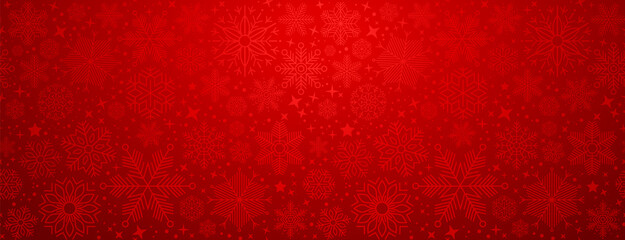 Christmas illustration with various small snowflakes on gradient background in red colors
