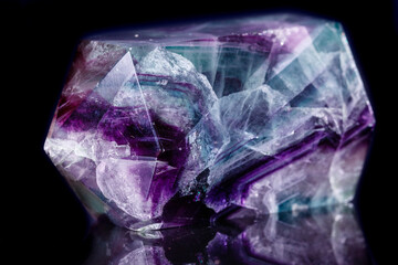 Macro mineral stone Fluorite crystal on a black background