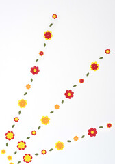 Bright red, yellow, orange paper flowers on white background. Spring, summer concept. Flat lay style with copy space