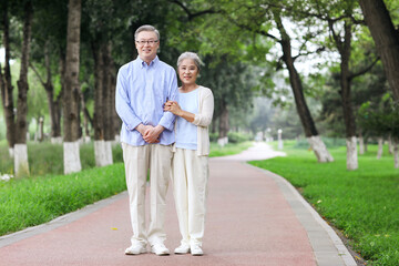 Fototapeta premium Happy old couple walking in the park