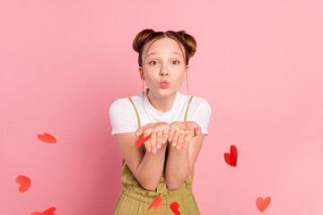 Portrait of attractive amorous affectionate girl sending air kiss hearts flying isolated over pink...
