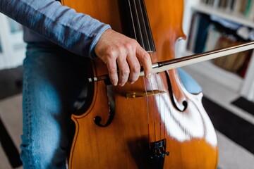 Detail of man touching the cello