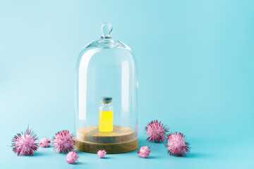 A vial with yellow liquid isolated inside a glass dome of virus particles. Medicine and coronavirus concept. isolation and quarantine concept. copy space.