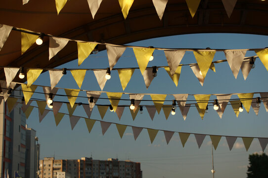 garland with flags and lamps at everning sky