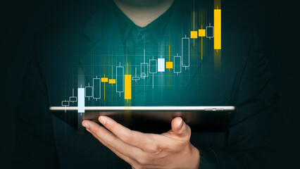 businessman holding hologram stock and teble, business growth concept.