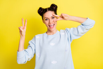 Photo of excited crazy lady open mouth showing two v-sign cover eye wear blue sweater isolated yellow background