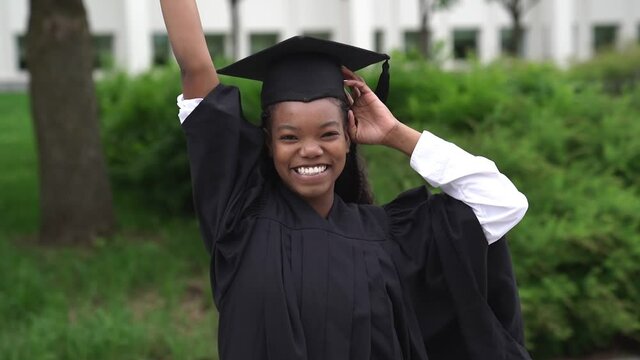 A happy afro american university graduates at graduation ceremony