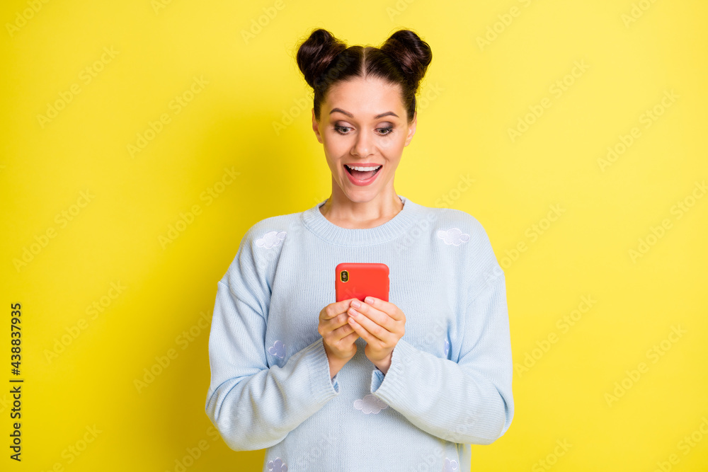 Canvas Prints Portrait of attractive amazed cheerful girl using device chatting media news comment isolated over vibrant yellow color background