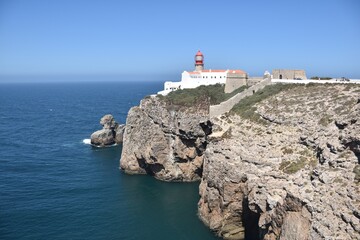 Fototapeta na wymiar Lighthouse at the cliffs of Cape Sao Vicente near Lagos, Algarve, Portugal