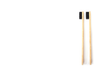 two bamboo toothbrushes on a white background.