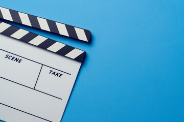 movie clapper on blue table background ; film, cinema and video photography concept