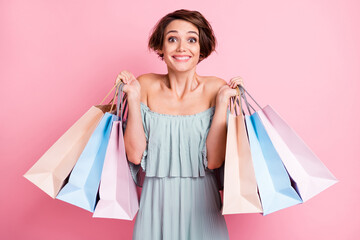 Photo of young cheerful girl happy positive smile hold shopping bags buy purchase sale isolated over pink color background