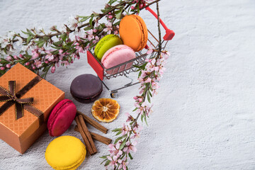 Macaroons cookies in a souvenir cart from the supermarket for groceries . Copy space. Sweet gift concept