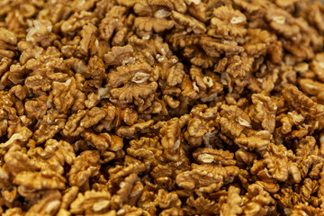 There are many shelled walnuts on the market counter. Healthy food, vitamins and veganism. Top view. Background.
