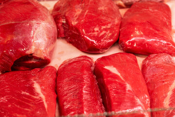 Fresh red meat on the market counter. Healthy eating. Close-up.