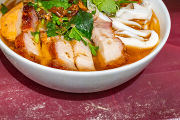 Vietnamese seafood noodle served with roasted pork, Bun Mam