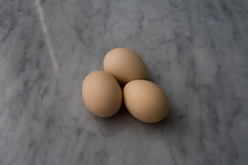 A group of eggs on the marble table.